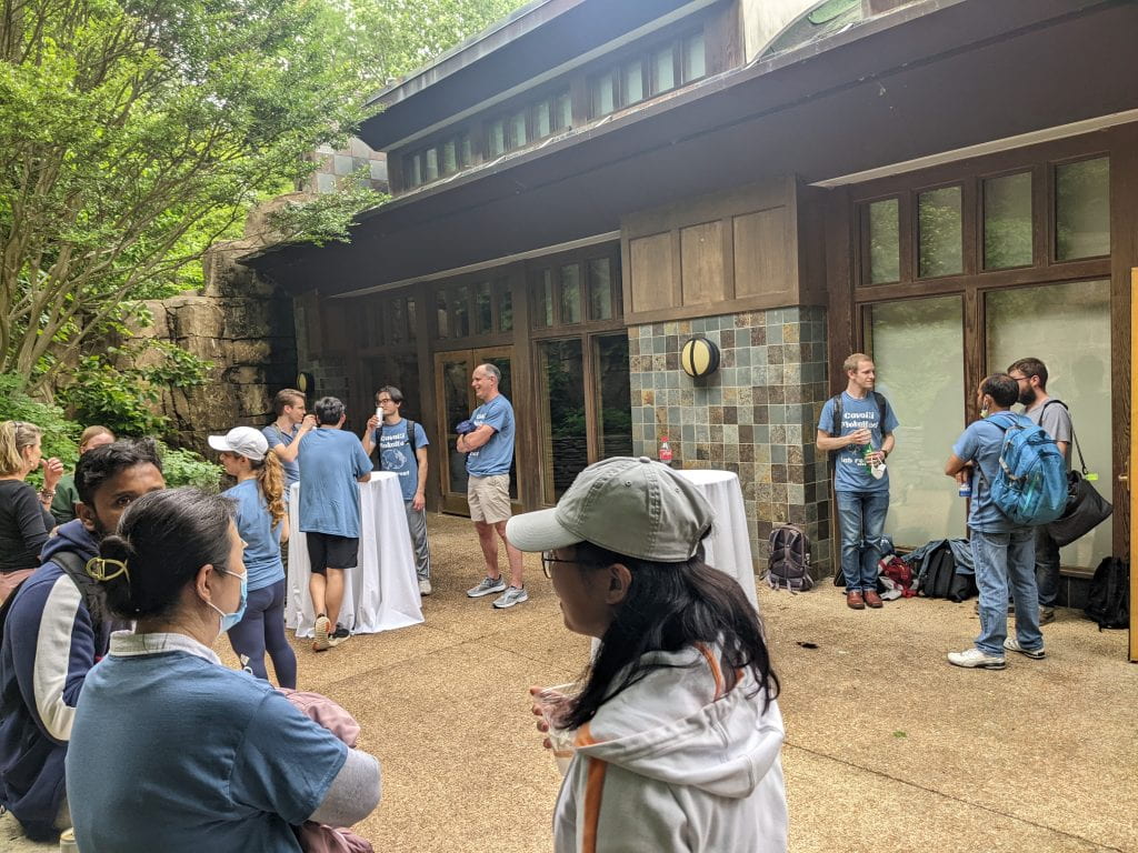 People standing outside at a happy hour at a zoo