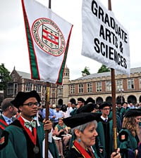 grad school banner in commencement procession