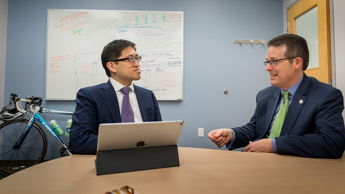 Albert Lai, PhD, (left), and Director Phillip Payne, PhD, meet in an office at the Institute for Informatics on December 7, 2017.